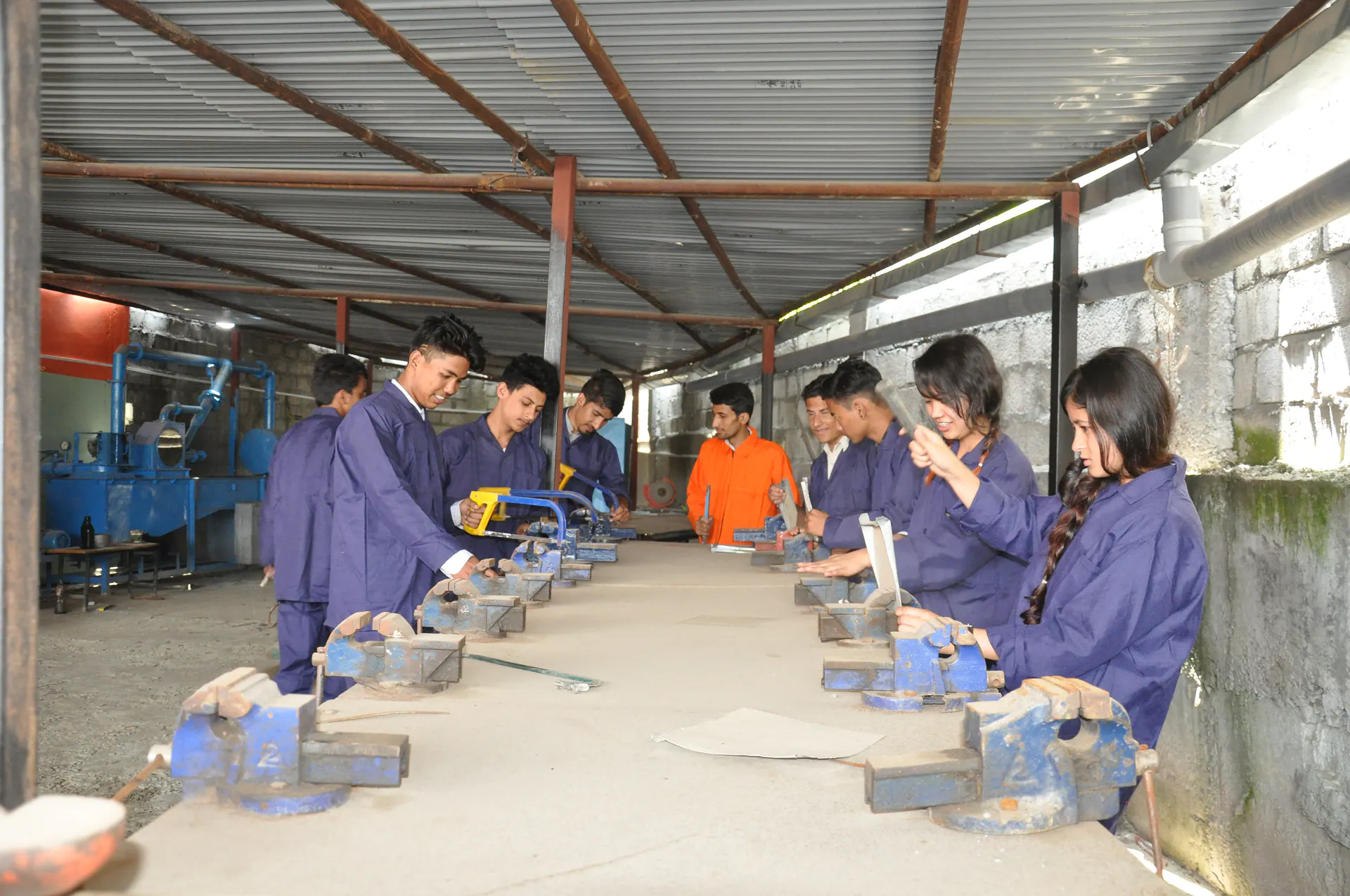ICE students completing practical work at benches in an engineering workshop